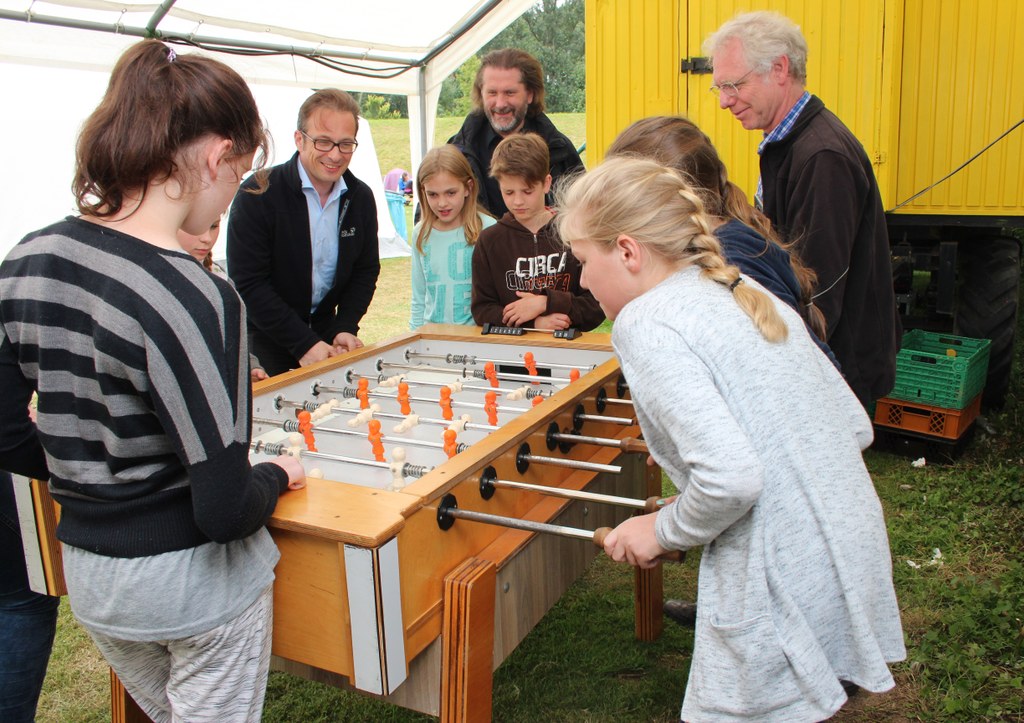 Bürgermeister Reiner Breuer (l.) und Jugendamtsleiter Markus Hübner hatten während ihres Besuches im Zeltlager Spaß beim Kickerspielen; rechts im Bild: Klaus Winkels vom Kontakt Erfttal. 